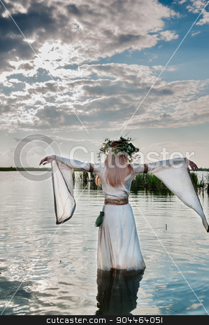 To use this stock image in your creative project, please select the size you need over to the right and click the "Add to Cart" button.
Your downloaded image will come with the Cutcaster watermark removed so don’t worry about the watermark you see on this page. Beautiful woman with flower wreath in watet stock photo, Attractive Woman with Wreath of Flowers walking in water of lake. Back view (Russian traditional holiday celebration) by Aikon