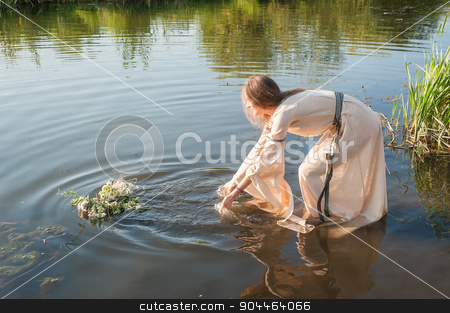 To use this stock image in your creative project, please select the size you need over to the right and click the "Add to Cart" button.
Your downloaded image will come with the Cutcaster watermark removed so don’t worry about the watermark you see on this page. Beautiful girl relaxes in water stock photo, Attractive woman in traditional dress in water of lake. Russian traditional Ivan Kupala holiday celebration by Aikon