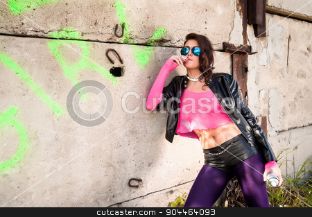 To use this stock image in your creative project, please select the size you need over to the right and click the "Add to Cart" button.
Your downloaded image will come with the Cutcaster watermark removed so don’t worry about the watermark you see on this page. Pretty girl in leather jacket smokes stock photo, Young beautiful woman in sunglasses with spray paint smokes at wall background by Aikon