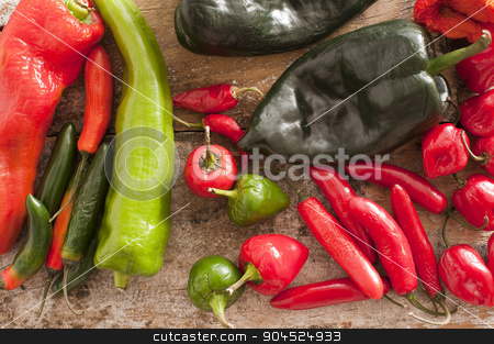 To use this stock image in your creative project, please select the size you need over to the right and click the "Add to Cart" button.
Your downloaded image will come with the Cutcaster watermark removed so don’t worry about the watermark you see on this page. Red and Green Chili Peppers on a Wooden Table stock photo, High Angle View of Assorted Red and Green Chili Peppers on a Rustic Wooden Table. by Stephen Gibson