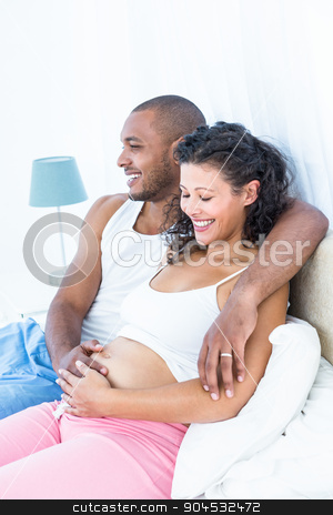 To use this stock image in your creative project, please select the size you need over to the right and click the "Add to Cart" button.
Your downloaded image will come with the Cutcaster watermark removed so don’t worry about the watermark you see on this page. Husband sitting on bed with pregnant wife stock photo, Husband sitting on bed with pregnant wife at home by Wavebreak Media