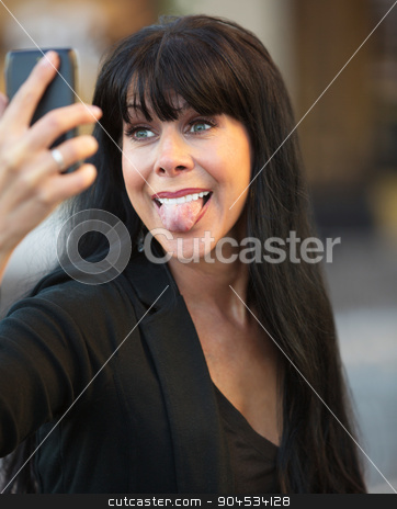 To use this stock image in your creative project, please select the size you need over to the right and click the "Add to Cart" button.
Your downloaded image will come with the Cutcaster watermark removed so don’t worry about the watermark you see on this page. Woman Sticking Out Her Tongue stock photo, Attractive woman sticks out her tongue taking a selfie by Scott Griessel