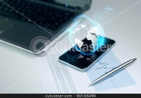 To use this stock image in your creative project, please select the size you need over to the right and click the "Add to Cart" button.
Your downloaded image will come with the Cutcaster watermark removed so don’t worry about the watermark you see on this page. close up of smartphone with earth globe hologram stock photo, business, technology and communication concept - close up of smartphone with earth globe hologram, laptop computer and chart with pen on office table by Syda Productions