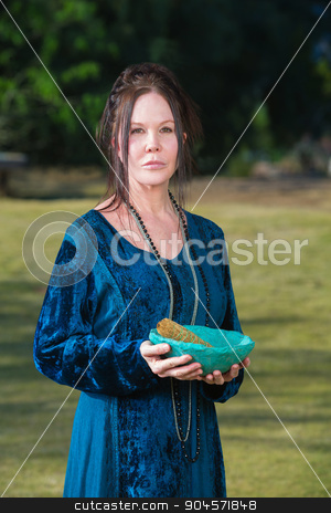 To use this stock image in your creative project, please select the size you need over to the right and click the "Add to Cart" button.
Your downloaded image will come with the Cutcaster watermark removed so don’t worry about the watermark you see on this page. Priestess with Sage Incense stock photo, Serious Wicca priestess with blue bowl sage incense by Scott Griessel
