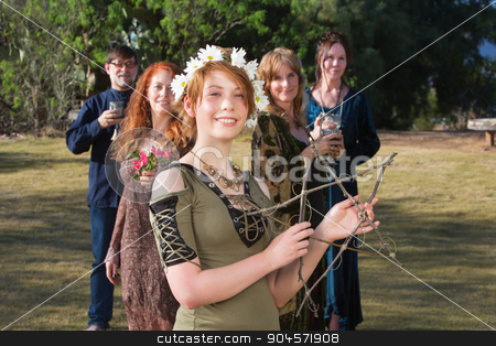To use this stock image in your creative project, please select the size you need over to the right and click the "Add to Cart" button.
Your downloaded image will come with the Cutcaster watermark removed so don’t worry about the watermark you see on this page. Woman Holding a Stick Pentagram stock photo, Young pagan woman with group holding a stick pentagram by Scott Griessel
