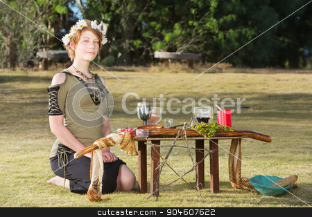 To use this stock image in your creative project, please select the size you need over to the right and click the "Add to Cart" button.
Your downloaded image will come with the Cutcaster watermark removed so don’t worry about the watermark you see on this page. Cute Pagan Woman with Wreath stock photo, Cute pagan woman with wreath sitting at outdoor altar by Scott Griessel
