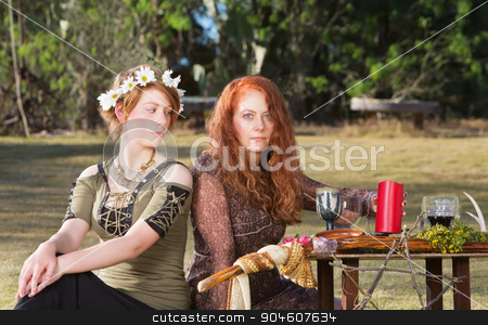 To use this stock image in your creative project, please select the size you need over to the right and click the "Add to Cart" button.
Your downloaded image will come with the Cutcaster watermark removed so don’t worry about the watermark you see on this page. Two Pagans at Altar stock photo, Two serious pagan females sitting at altar with candles by Scott Griessel