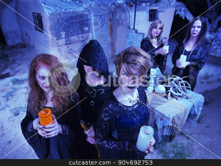 To use this stock image in your creative project, please select the size you need over to the right and click the "Add to Cart" button.
Your downloaded image will come with the Cutcaster watermark removed so don’t worry about the watermark you see on this page. Coven of Five Witches stock photo, Coven of five witches outdoors holding candles by Scott Griessel