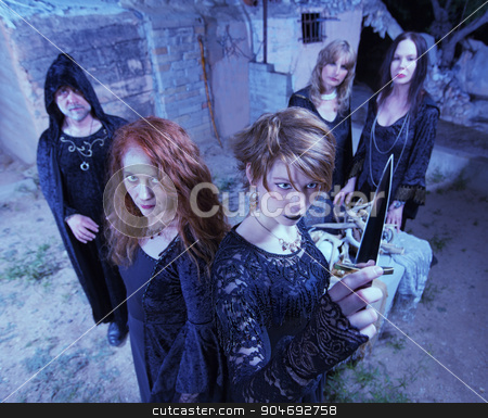 To use this stock image in your creative project, please select the size you need over to the right and click the "Add to Cart" button.
Your downloaded image will come with the Cutcaster watermark removed so don’t worry about the watermark you see on this page. Occult Sacrifice Ritual stock photo, Five witches with dagger in occult sacrifice ritual by Scott Griessel