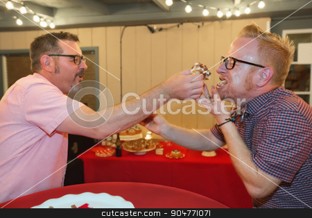 To use this stock image in your creative project, please select the size you need over to the right and click the "Add to Cart" button.
Your downloaded image will come with the Cutcaster watermark removed so don’t worry about the watermark you see on this page. Gay Men Share Cake stock photo, Gay male couple share bacon cupcake at their wedding by Scott Griessel