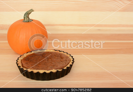 To use this stock image in your creative project, please select the size you need over to the right and click the "Add to Cart" button.
Your downloaded image will come with the Cutcaster watermark removed so don’t worry about the watermark you see on this page. Mini pumpkin pie with orange pumpkin on wood stock photo, Mini pumpkin pie with small orange pumpkin on a wooden background, with copy space by Sarah Marchant