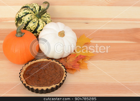 To use this stock image in your creative project, please select the size you need over to the right and click the "Add to Cart" button.
Your downloaded image will come with the Cutcaster watermark removed so don’t worry about the watermark you see on this page. Fall pumpkins and leaves with pumpkin pie stock photo, Autumnal pumpkins and maple leaves with small pumpkin pie on a pine table, with copy space by Sarah Marchant
