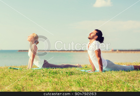 To use this stock image in your creative project, please select the size you need over to the right and click the "Add to Cart" button.
Your downloaded image will come with the Cutcaster watermark removed so don’t worry about the watermark you see on this page. smiling couple making yoga exercises outdoors stock photo, fitness, sport, friendship and lifestyle concept - smiling couple making yoga exercises lying on mats outdoors by Syda Productions