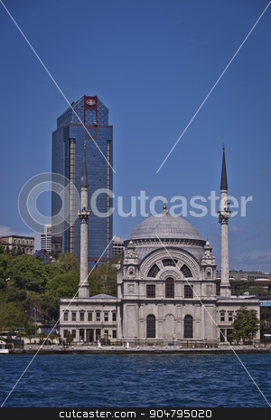 To use this stock image in your creative project, please select the size you need over to the right and click the "Add to Cart" button.
Your downloaded image will come with the Cutcaster watermark removed so don’t worry about the watermark you see on this page. Dolmabahce Mosque on the Bosphorus in Istanbul stock photo, ISTANBUL, TURKEY – APRIL 27: Traditional Dolmabahce Mosque on the Bosphorus in Istanbul with modern office building behind on April 27, 2012 in Istanbul, Turkey. by Scott Griessel