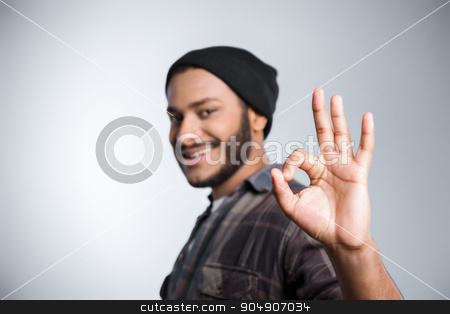 To use this stock image in your creative project, please select the size you need over to the right and click the "Add to Cart" button.
Your downloaded image will come with the Cutcaster watermark removed so don’t worry about the watermark you see on this page. Freestyle photo with young mulatto stock photo, Young mixed race man with beard standing on grey background. Young man smiling and showing ok sign by Dmytro Sidelnikov