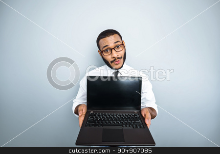 To use this stock image in your creative project, please select the size you need over to the right and click the "Add to Cart" button.
Your downloaded image will come with the Cutcaster watermark removed so don’t worry about the watermark you see on this page. Freestyle photo with young mulatto stock photo, Young mixed race businessman with beard standing on grey background. Young man showing laptop by Dmytro Sidelnikov