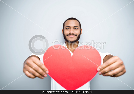 To use this stock image in your creative project, please select the size you need over to the right and click the "Add to Cart" button.
Your downloaded image will come with the Cutcaster watermark removed so don’t worry about the watermark you see on this page. Freestyle photo with young mulatto stock photo, Young mixed race man with beard standing on grey background. Young man showing red paper heart by Dmytro Sidelnikov