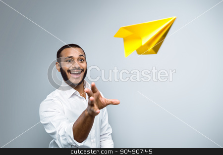 To use this stock image in your creative project, please select the size you need over to the right and click the "Add to Cart" button.
Your downloaded image will come with the Cutcaster watermark removed so don’t worry about the watermark you see on this page. Freestyle photo with young mulatto stock photo, Young mixed race man with beard standing on grey background. Young man starting up yellow paper plane by Dmytro Sidelnikov
