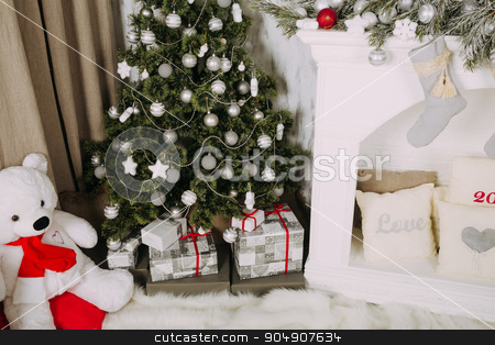 To use this stock image in your creative project, please select the size you need over to the right and click the "Add to Cart" button.
Your downloaded image will come with the Cutcaster watermark removed so don’t worry about the watermark you see on this page. Christmas tree with gifts at fireplace stock photo, New Year's home decoration with silver Christmas balls by sunapple