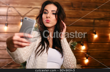 To use this stock image in your creative project, please select the size you need over to the right and click the "Add to Cart" button.
Your downloaded image will come with the Cutcaster watermark removed so don’t worry about the watermark you see on this page. Portrait of a beautiful brunette taking a selfie with her smart phone at home stock photo, Portrait of a beautiful brunette taking a selfie with her smart phone by mykhalets
