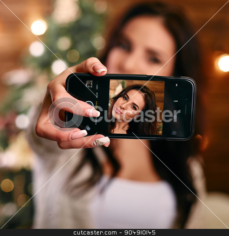 To use this stock image in your creative project, please select the size you need over to the right and click the "Add to Cart" button.
Your downloaded image will come with the Cutcaster watermark removed so don’t worry about the watermark you see on this page. people, holidays and technology concept - beautiful brunette woman in white sweater taking selfie picture by smartphone over christmas tree and living room background stock photo, people, holidays and technology concept - beautiful brunette woman in white Christmas sweater taking selfie picture by smartphone over christmas tree living room background by mykhalets