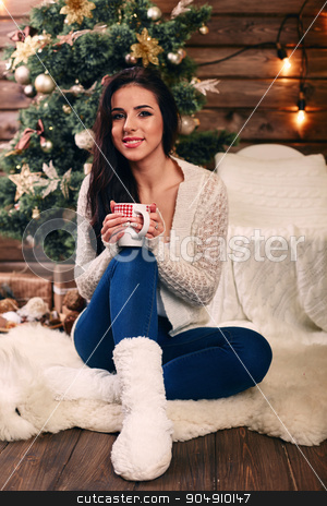 To use this stock image in your creative project, please select the size you need over to the right and click the "Add to Cart" button.
Your downloaded image will come with the Cutcaster watermark removed so don’t worry about the watermark you see on this page. Beautiful young woman drinking tea at the Christmas tree. Beautiful girl celebrates Christmas with a cup of cocoa in front of tree over living room stock photo, Beautiful young woman drinking tea at the Christmas tree. Beautiful girl celebrates Christmas with a cup of cocoa in front of tree by mykhalets