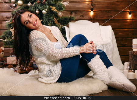 To use this stock image in your creative project, please select the size you need over to the right and click the "Add to Cart" button.
Your downloaded image will come with the Cutcaster watermark removed so don’t worry about the watermark you see on this page. Young woman near a Christmas tree holding gift box while sitting near Christmas Tree stock photo, Christmas young woman near a Christmas tree holding gift box while sitting near Christmas Tree by mykhalets