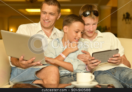 To use this stock image in your creative project, please select the size you need over to the right and click the "Add to Cart" button.
Your downloaded image will come with the Cutcaster watermark removed so don’t worry about the watermark you see on this page. Father and sons with laptop stock photo, Father and sons with laptop at the table by Ruslan Huzau