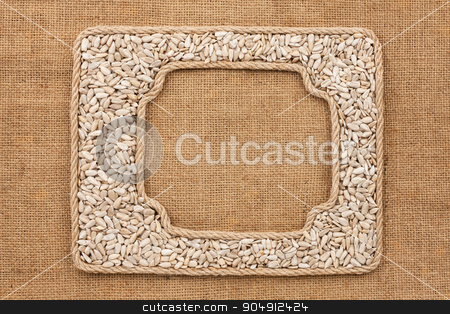 To use this stock image in your creative project, please select the size you need over to the right and click the "Add to Cart" button.
Your downloaded image will come with the Cutcaster watermark removed so don’t worry about the watermark you see on this page. Two frames made of rope with sunflower seeds on sackcloth stock photo, Two frames made of rope with sunflower seeds on sackcloth, as background, texture
by alekleks