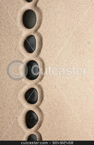 To use this stock image in your creative project, please select the size you need over to the right and click the "Add to Cart" button.
Your downloaded image will come with the Cutcaster watermark removed so don’t worry about the watermark you see on this page. Line of black stones lying on the sand stock photo, Line of black stones lying on the sand, with space for your text by alekleks