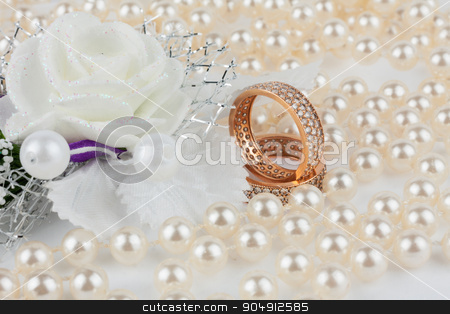 To use this stock image in your creative project, please select the size you need over to the right and click the "Add to Cart" button.
Your downloaded image will come with the Cutcaster watermark removed so don’t worry about the watermark you see on this page. Wedding rings among the pearls with flower stock photo, Wedding rings among the pearls with flower, as background by alekleks