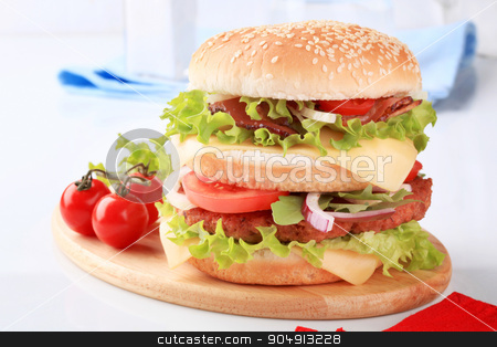 To use this stock image in your creative project, please select the size you need over to the right and click the "Add to Cart" button.
Your downloaded image will come with the Cutcaster watermark removed so don’t worry about the watermark you see on this page. Double burger stock photo, Sesame seed bun sandwich with beef patty, parma ham and cheese by Digifoodstock
