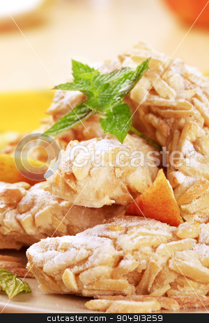 To use this stock image in your creative project, please select the size you need over to the right and click the "Add to Cart" button.
Your downloaded image will come with the Cutcaster watermark removed so don’t worry about the watermark you see on this page. Almond cookies stock photo, Cookies rolled in chopped almonds and powdered sugar by Digifoodstock