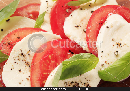 To use this stock image in your creative project, please select the size you need over to the right and click the "Add to Cart" button.
Your downloaded image will come with the Cutcaster watermark removed so don’t worry about the watermark you see on this page. Caprese salad stock photo, Slices of fresh mozzarella cheese and tomato by Digifoodstock