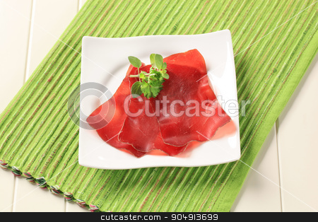 To use this stock image in your creative project, please select the size you need over to the right and click the "Add to Cart" button.
Your downloaded image will come with the Cutcaster watermark removed so don’t worry about the watermark you see on this page. Dried meat stock photo, Thin slices of dried meat on a square plate by Digifoodstock