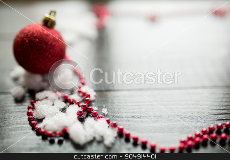 To use this stock image in your creative project, please select the size you need over to the right and click the "Add to Cart" button.
Your downloaded image will come with the Cutcaster watermark removed so don’t worry about the watermark you see on this page. Red Christmas ball on snow on black wooden background stock photo, Christmas decoration closeup snowy background by sunapple