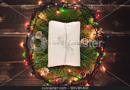 To use this stock image in your creative project, please select the size you need over to the right and click the "Add to Cart" button.
Your downloaded image will come with the Cutcaster watermark removed so don’t worry about the watermark you see on this page. Christmas gift in the wreath stock photo, Christmas craft rustic gift closeup on the wooden table with garland lights by sunapple
