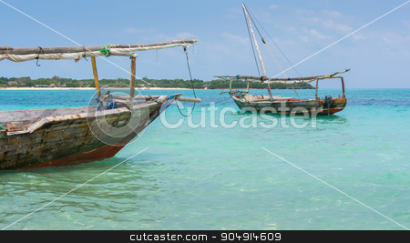 To use this stock image in your creative project, please select the size you need over to the right and click the "Add to Cart" button.
Your downloaded image will come with the Cutcaster watermark removed so don’t worry about the watermark you see on this page. Two Dhow boats stock photo, Anchored wooden dhow boats on the amazing turquoise water in the Indian ocean Zanzibar, Tanzania. by Robertobinetti70