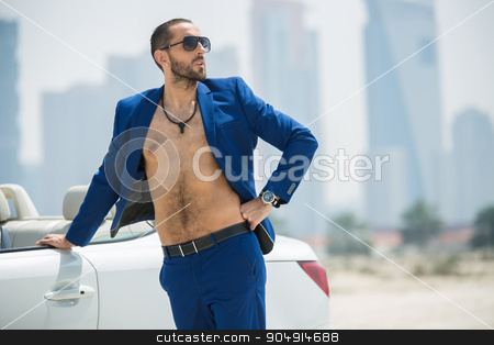 To use this stock image in your creative project, please select the size you need over to the right and click the "Add to Cart" button.
Your downloaded image will come with the Cutcaster watermark removed so don’t worry about the watermark you see on this page. Man on the background of skyscrapers stock photo, Wealthy man arrived in a white car to walk on a deserted beach on the background of skyscrapers in Dubai. He wore a blue suit and naked torso. OAE by bezikus