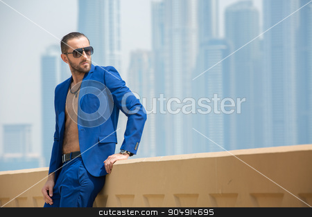 To use this stock image in your creative project, please select the size you need over to the right and click the "Add to Cart" button.
Your downloaded image will come with the Cutcaster watermark removed so don’t worry about the watermark you see on this page. Man on the background of skyscrapers stock photo, Elegant man in a blue suit with a naked torso resting on the terrace in the background nebostrebov Dubai. UAE. Horizontal photo by bezikus