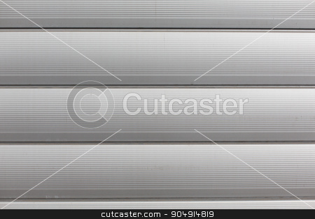 To use this stock image in your creative project, please select the size you need over to the right and click the "Add to Cart" button.
Your downloaded image will come with the Cutcaster watermark removed so don’t worry about the watermark you see on this page. close up of aluminum metal garage door backdrop stock photo, background and texture - close up of aluminum metal garage door backdrop by Syda Productions