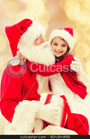 To use this stock image in your creative project, please select the size you need over to the right and click the "Add to Cart" button.
Your downloaded image will come with the Cutcaster watermark removed so don’t worry about the watermark you see on this page. smiling little girl with santa claus stock photo, holidays, christmas, childhood and people concept - smiling little girl hugging with santa claus over beige lights background by Syda Productions