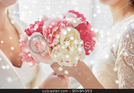 To use this stock image in your creative project, please select the size you need over to the right and click the "Add to Cart" button.
Your downloaded image will come with the Cutcaster watermark removed so don’t worry about the watermark you see on this page. close up of happy lesbian couple with flowers stock photo, people, homosexuality, same-sex marriage and love concept - close up of happy married lesbian couple with flower bunch over snow effect by Syda Productions