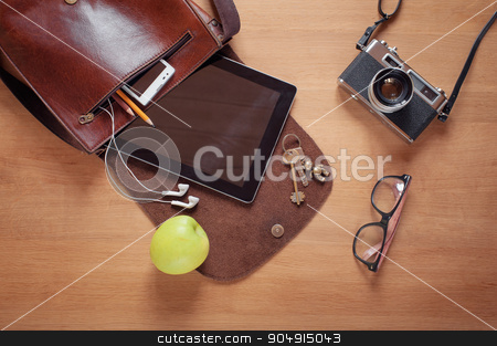 To use this stock image in your creative project, please select the size you need over to the right and click the "Add to Cart" button.
Your downloaded image will come with the Cutcaster watermark removed so don’t worry about the watermark you see on this page. Overhead of essentials for modern young person stock photo, Outfit of traveler, student, teenager, young man. Overhead of essentials for modern young person. Different objects on wooden background: leather bag, camera, smartphone, glasses, keys, digital tablet by Oleksii
