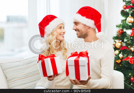 To use this stock image in your creative project, please select the size you need over to the right and click the "Add to Cart" button.
Your downloaded image will come with the Cutcaster watermark removed so don’t worry about the watermark you see on this page. happy couple at home exchanging christmas gifts stock photo, christmas, holidays and people concept - happy couple in santa hats exchanging gifts at home by Syda Productions