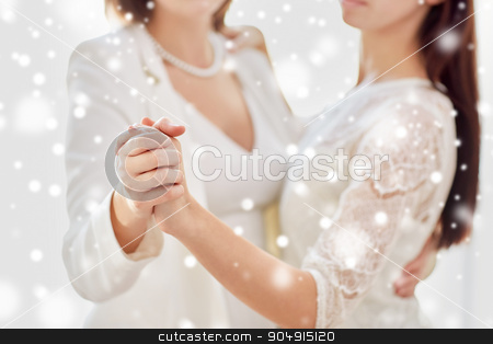 To use this stock image in your creative project, please select the size you need over to the right and click the "Add to Cart" button.
Your downloaded image will come with the Cutcaster watermark removed so don’t worry about the watermark you see on this page. close up of happy married lesbian couple dancing stock photo, people, homosexuality, same-sex marriage and love concept - close up of happy married lesbian couple dancing over snow effect by Syda Productions