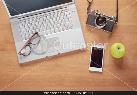 To use this stock image in your creative project, please select the size you need over to the right and click the "Add to Cart" button.
Your downloaded image will come with the Cutcaster watermark removed so don’t worry about the watermark you see on this page. Overhead of modern comfort work place stock photo, Overhead of modern comfort work place. Different objects on wooden background. Items include camera, glasses, laptop, smartphone and apple by Oleksii