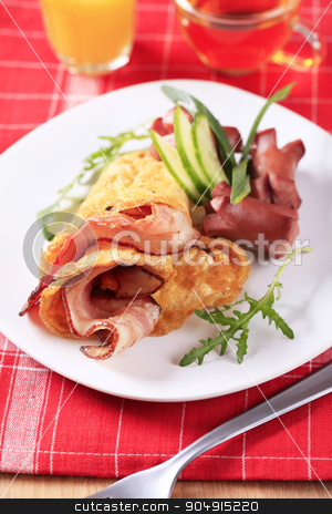 To use this stock image in your creative project, please select the size you need over to the right and click the "Add to Cart" button.
Your downloaded image will come with the Cutcaster watermark removed so don’t worry about the watermark you see on this page. Fry-up stock photo, Fried egg omelet with bacon and sausages by Digifoodstock