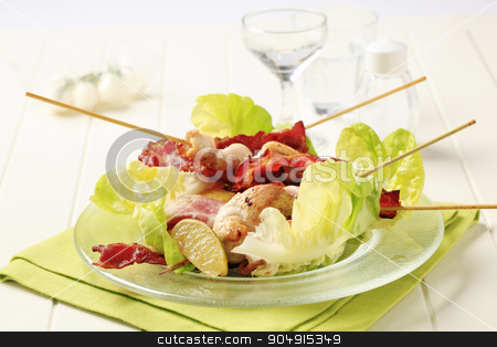 To use this stock image in your creative project, please select the size you need over to the right and click the "Add to Cart" button.
Your downloaded image will come with the Cutcaster watermark removed so don’t worry about the watermark you see on this page. Chicken skewers and crispy bacon stock photo, Chicken skewers and bacon strips served on lettuce leaves by Digifoodstock