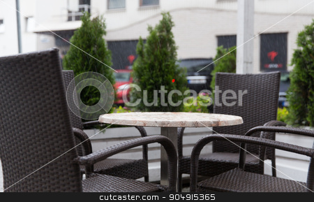 To use this stock image in your creative project, please select the size you need over to the right and click the "Add to Cart" button.
Your downloaded image will come with the Cutcaster watermark removed so don’t worry about the watermark you see on this page. table and chairs on street cafe terrace under rain stock photo, weather, public places and season concept - table and wicker chairs on street cafe terrace under rain by Syda Productions